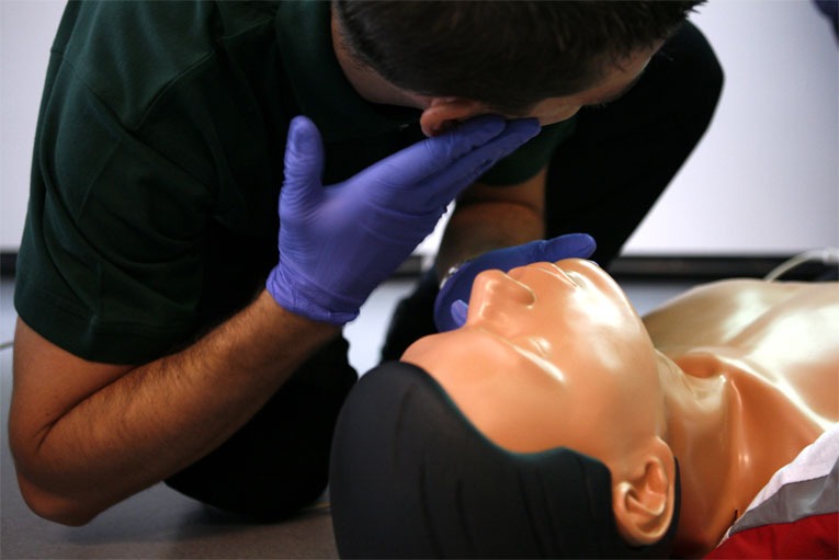 CPR on dummy if breading