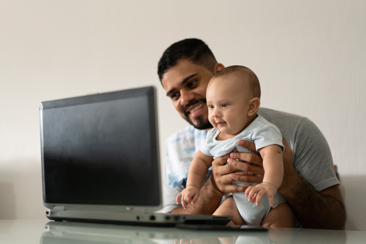 Father and child looking at screen
