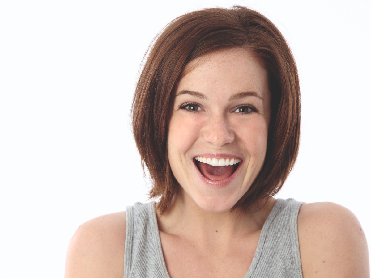 woman laughing with a white background